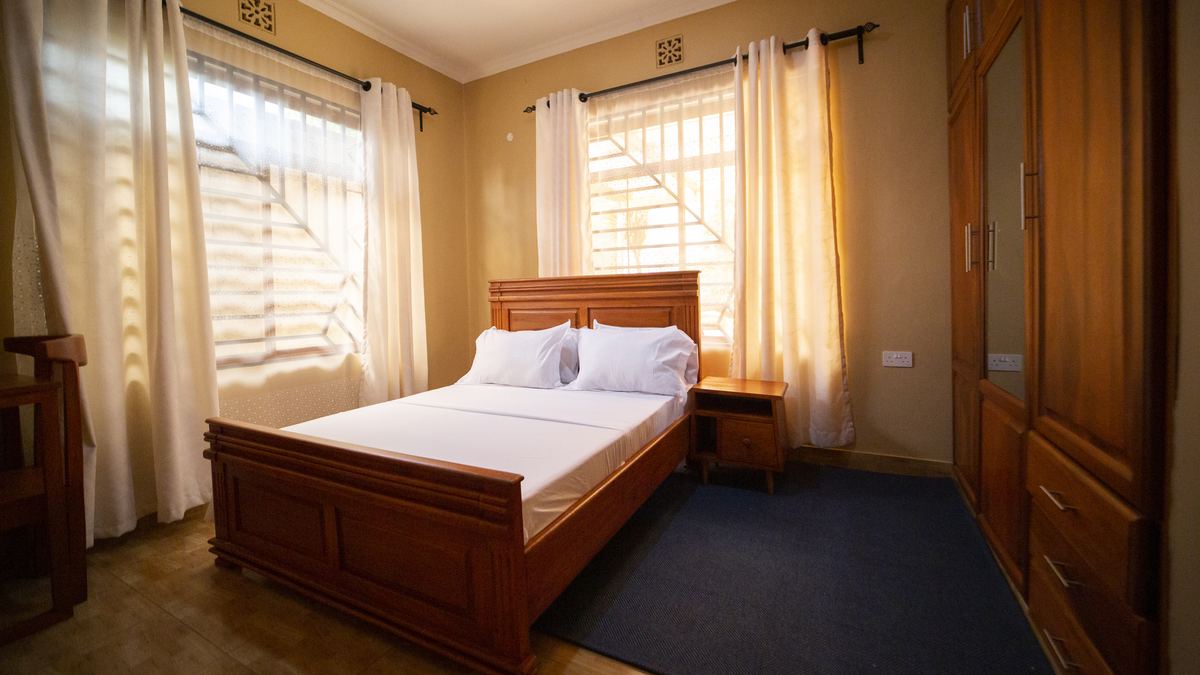 Double bed with wooden headboard and bedside tables