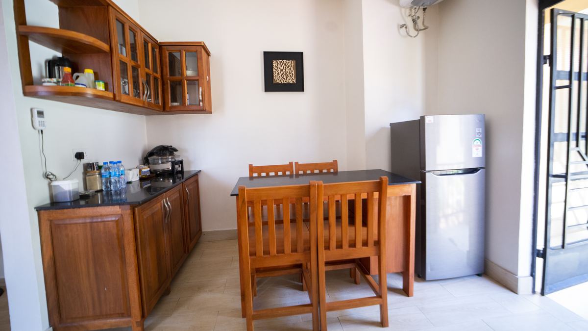 Dining table, fridge and wall cabinets in the kitchen