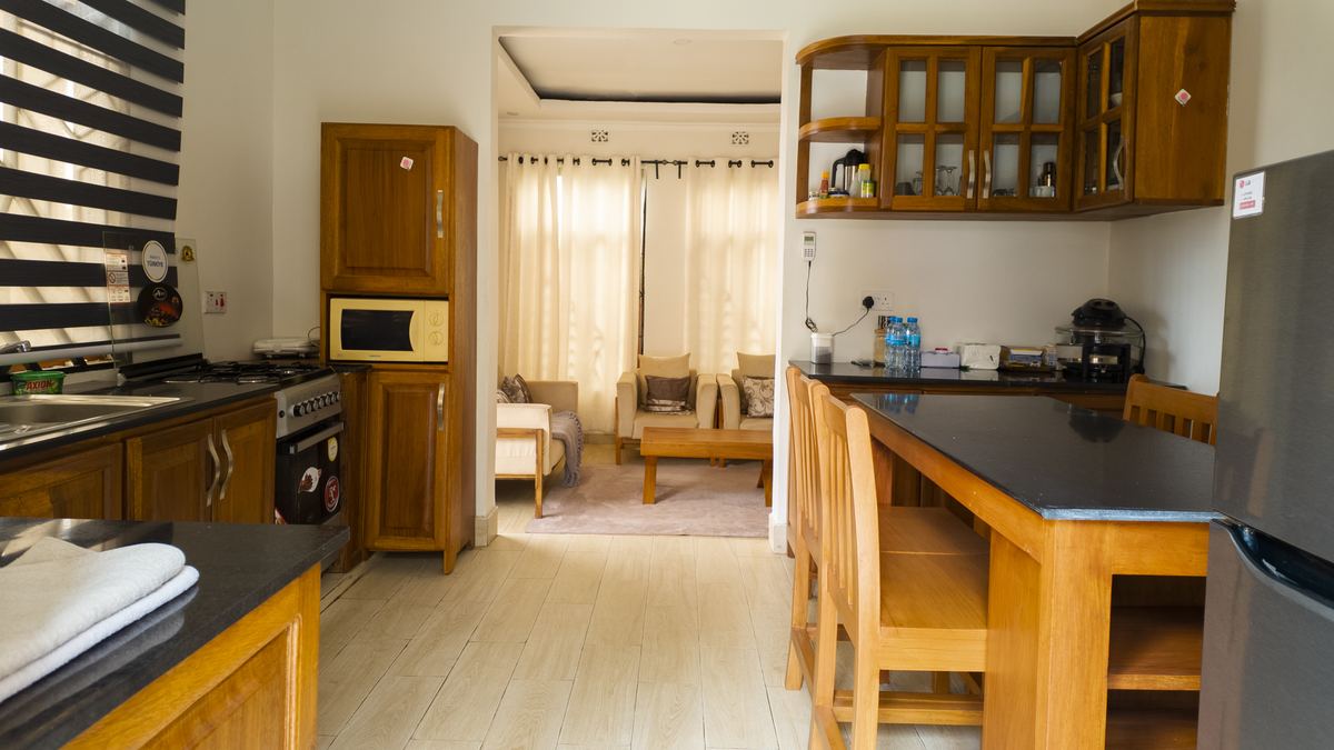 Open kitchen and dining corner with fridge