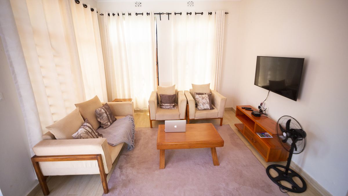 Furnished sitting room with sofas, wooden coffee table and TV
