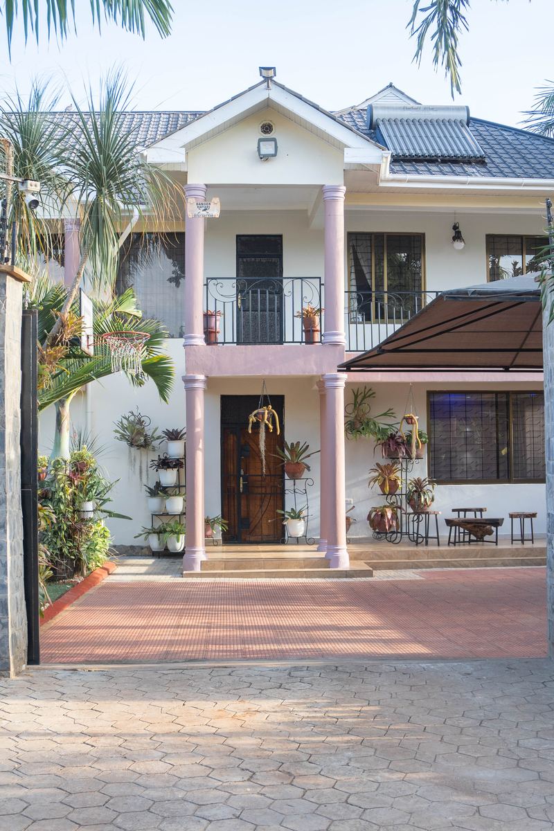 Front of the Cultural Home with balcony and potted plants