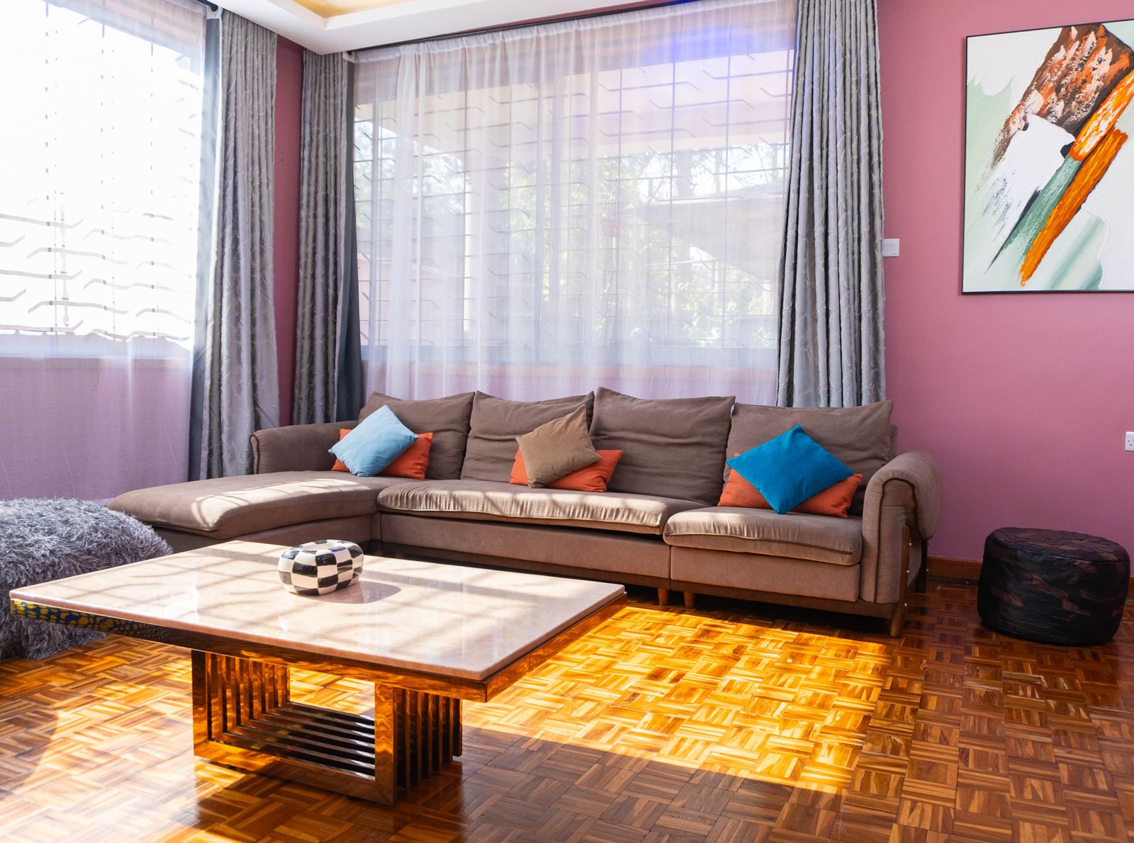 Sunlit lounge with corner sofa and colourful cushions